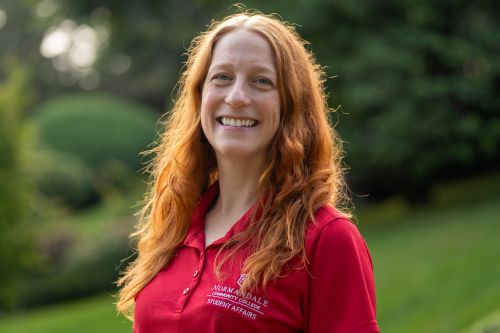 Picture of Paige Wheeler, a smiling woman with long red hair